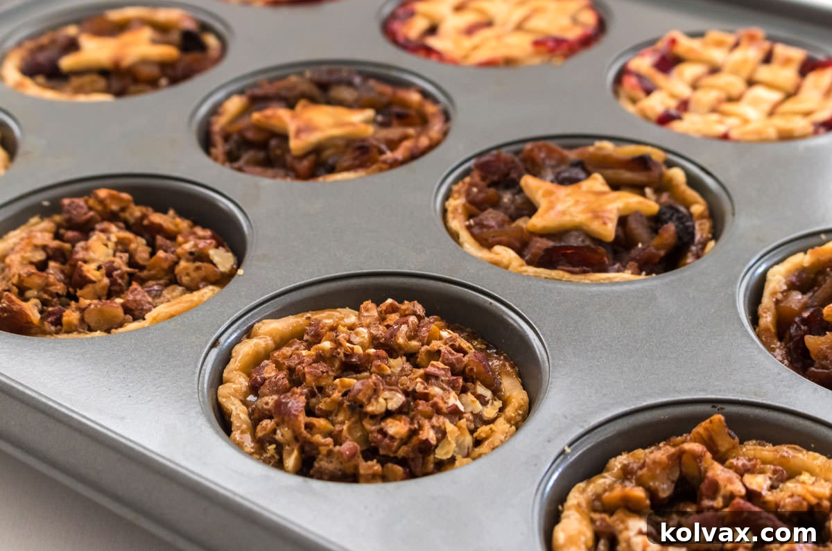 Closeup on a muffin tin filled with three different flavors of Mini Pies, illustrating the convenience of baking multiple varieties at once.