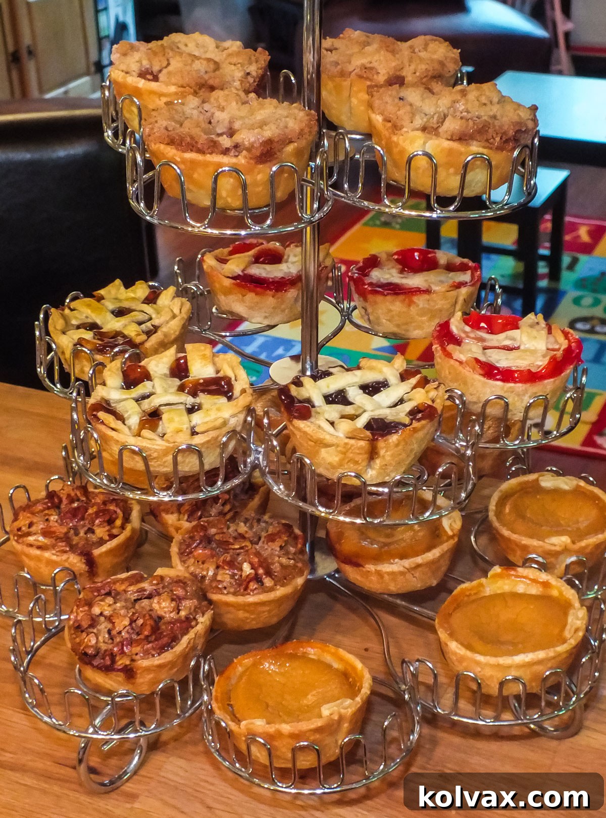 Closeup on a Cupcake Stand filled with Mini Pies for the Holidays of various flavors including Mince, Cherry, Pecan, Pumpkin and Apple, presenting a festive and inviting dessert spread.
