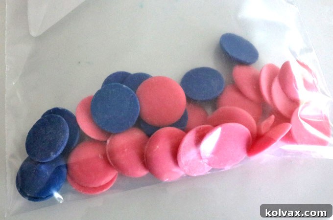 Candy Melts for drizzle on top of the cake - Wilton Candy Melts in pink and blue, prepared for melting and mixing to create a custom purple drizzle, adding an extra layer of visual appeal and sweetness to the Ombre Rice Krispie Cake.