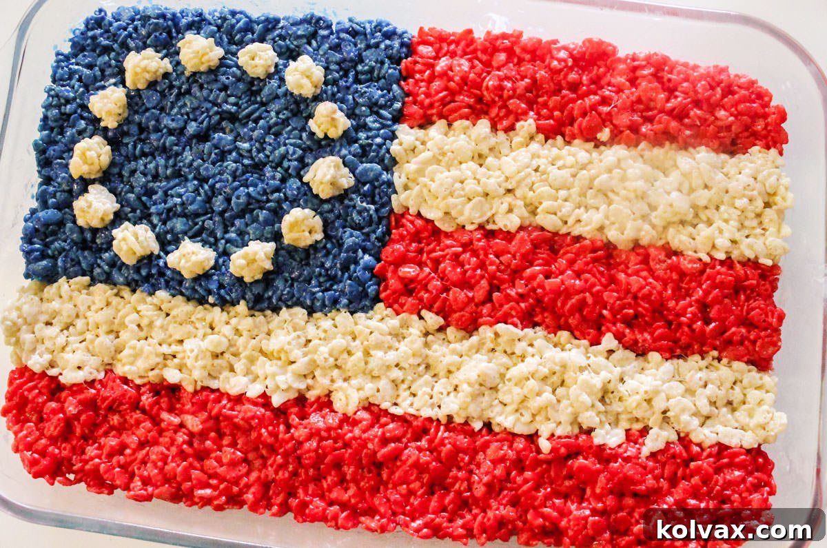 Closeup on a Colonial American Flag Rice Krispie Treat in a glass baking pan sitting on a white table.