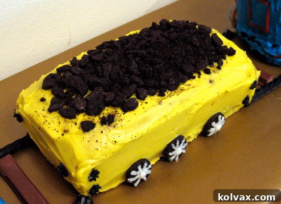 The full Thomas the Train cake display, showcasing the main engine, a coal car, and an animal car, all connected to form a vibrant birthday train.