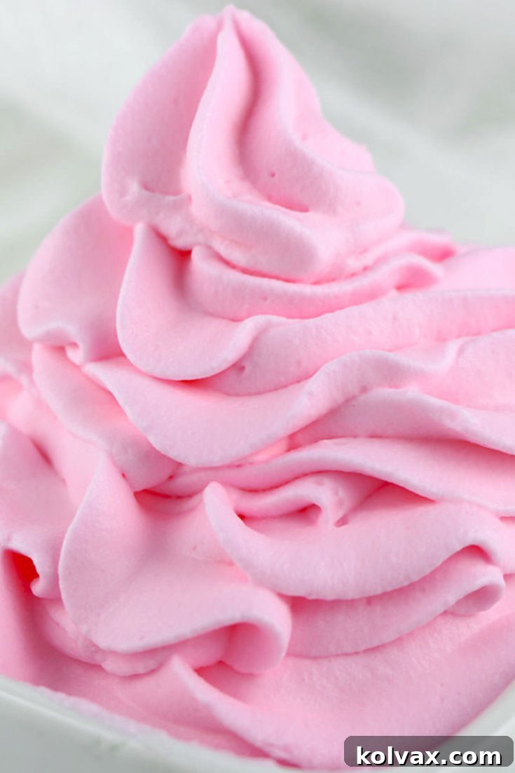 Recipe card image for homemade colored whipped cream, featuring a dollop of vibrant pink whipped cream.