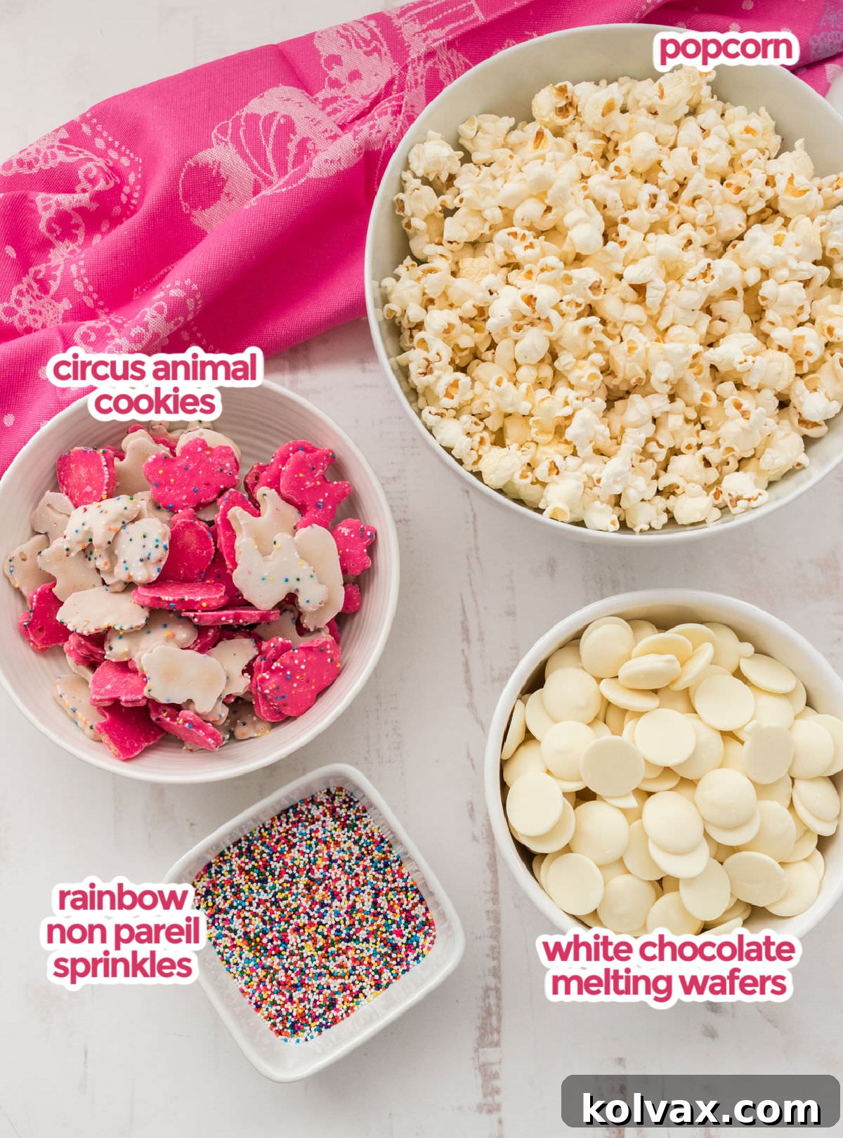 All the ingredients you will need to make Circus Animal Popcorn including popcorn, white chocolate melting wafers, Circus Animal Cookies, and rainbow non pareil sprinkles.