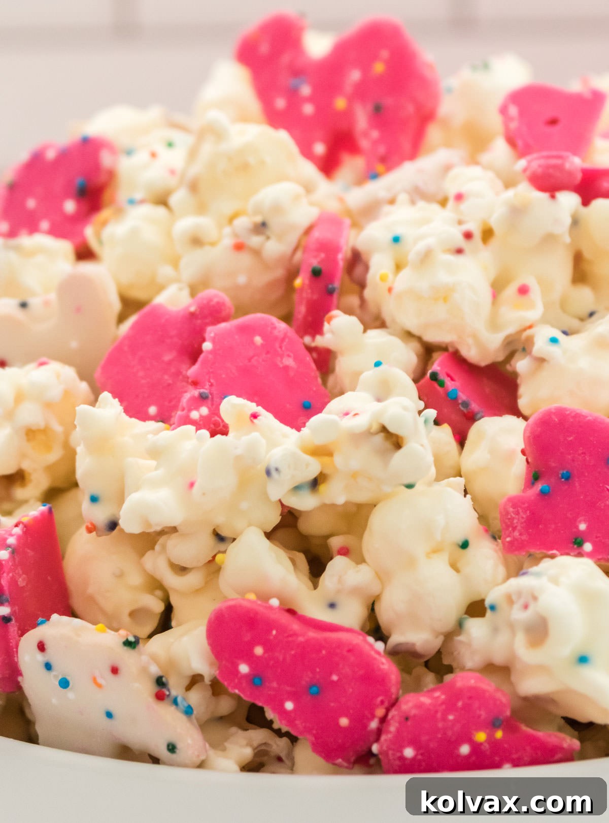 Closeup on a white serving bowl filled with Circus Animal Popcorn.