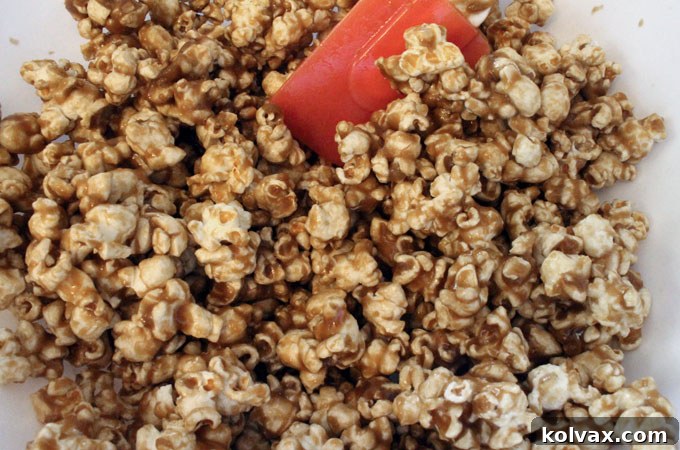 Pouring caramel mixture over popped popcorn
