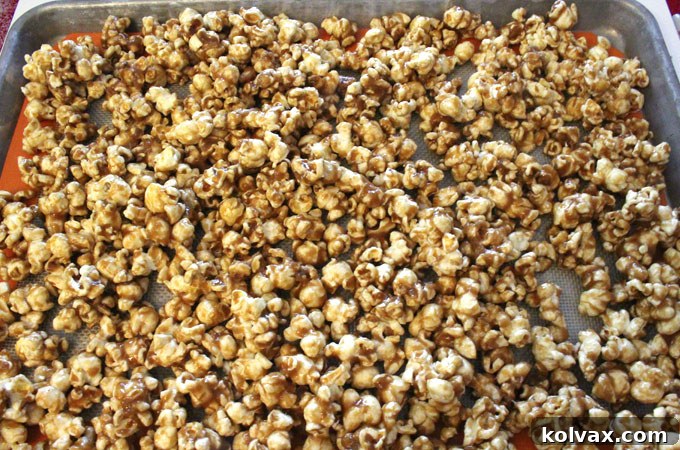 Spreading caramel corn onto a cookie sheet