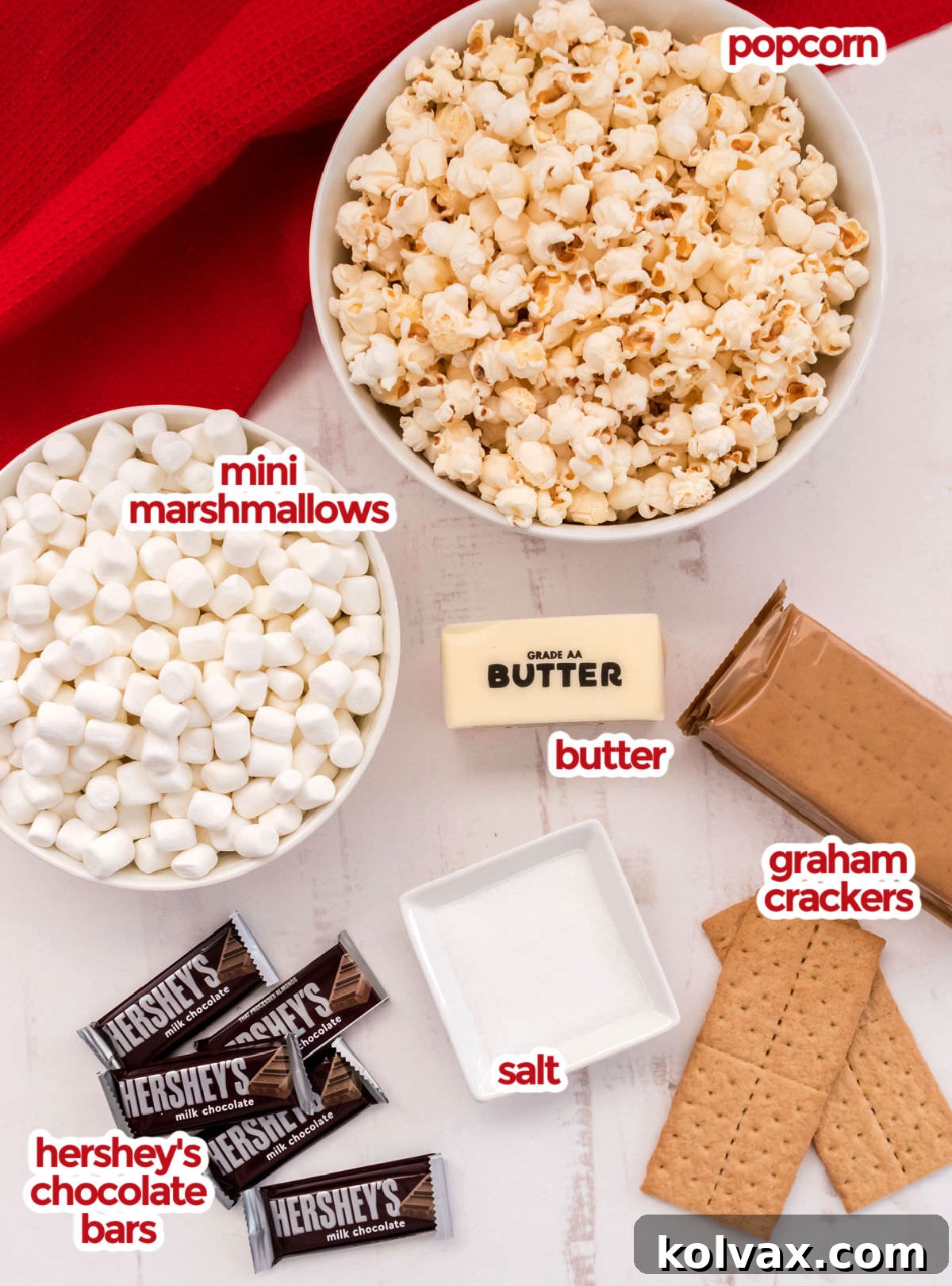 Campfire Crunch Popcorn 3 All the ingredients you will need to make S'mores Popcorn including popcorn kernels, butter, salt, mini marshmallows, graham crackers, and Hershey's Milk Chocolate Bars, neatly arranged for preparation.