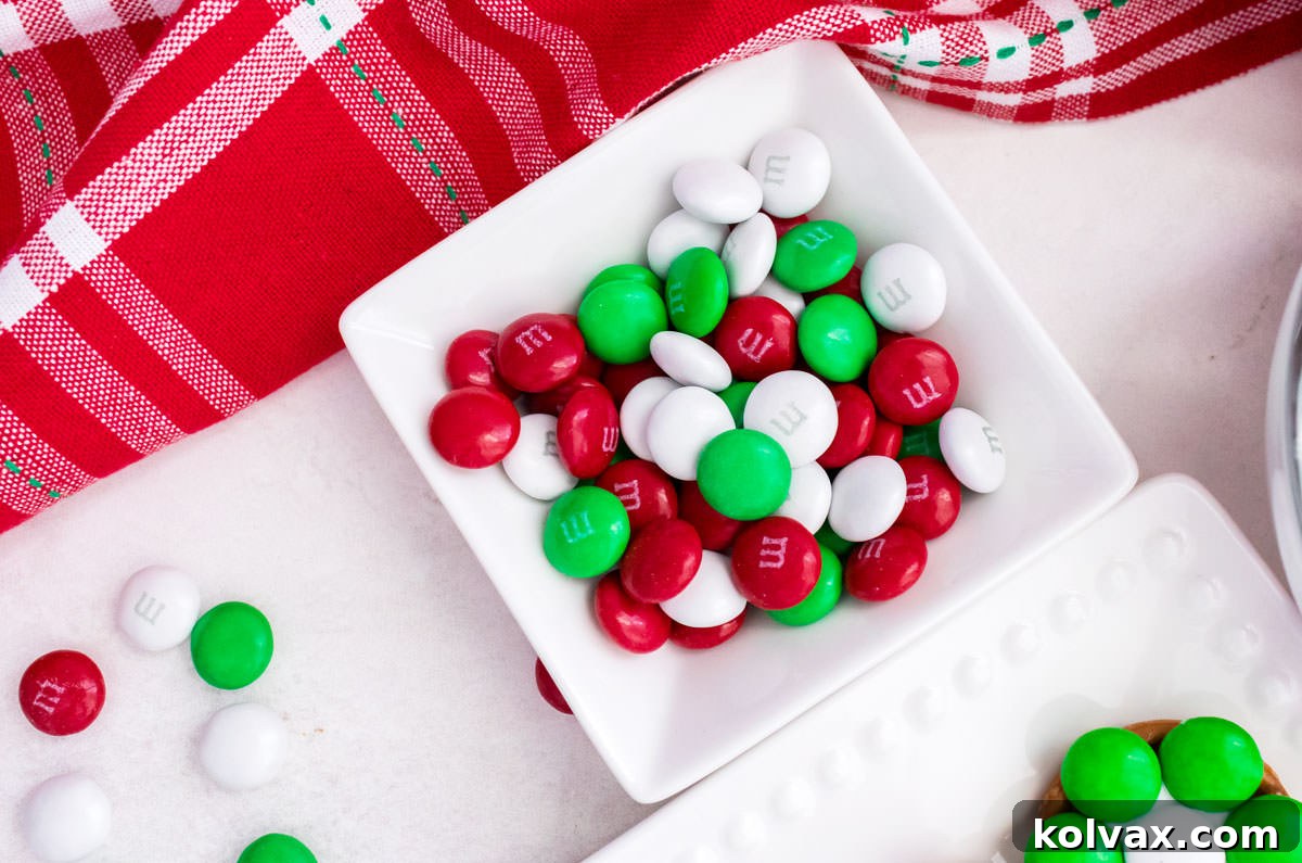 Closeup on a white ramekin filled with Red, White and Green M&M's.