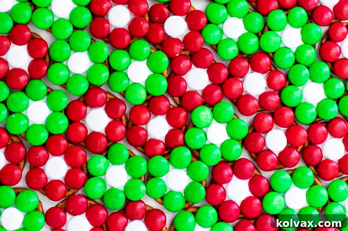 Closeup on a large batch of Christmas Flower Pretzel Bites all lined up in rows.