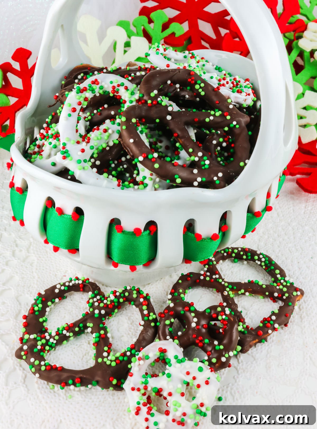 Sweet and Salty Chocolate Pretzel Perfection 6 Homemade Chocolate Covered Pretzels in a white decorative bowl surrounded by Christmas decorations and ornaments.