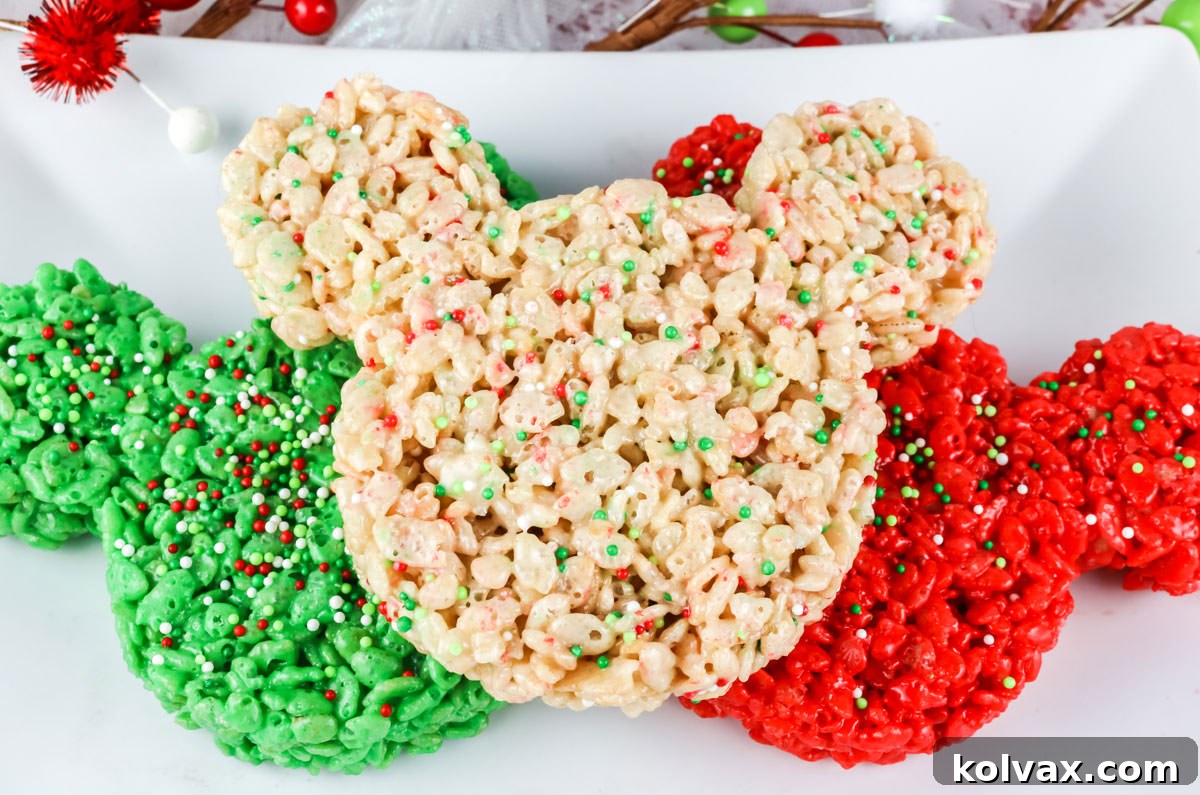 Close-up of festive red, green, and white Christmas Mickey Mouse Rice Krispie Treats arranged on a pristine white serving platter.