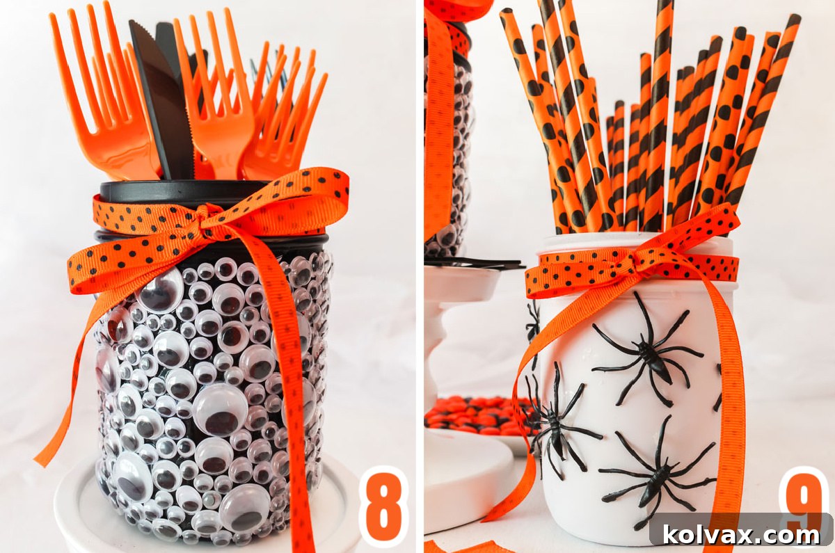 Close-up of the finished Spooky Eyes Mason Jar filled with plastic party spoons and the Spooky Spider Mason Jar holding Halloween-themed straws, showcasing their functionality.
