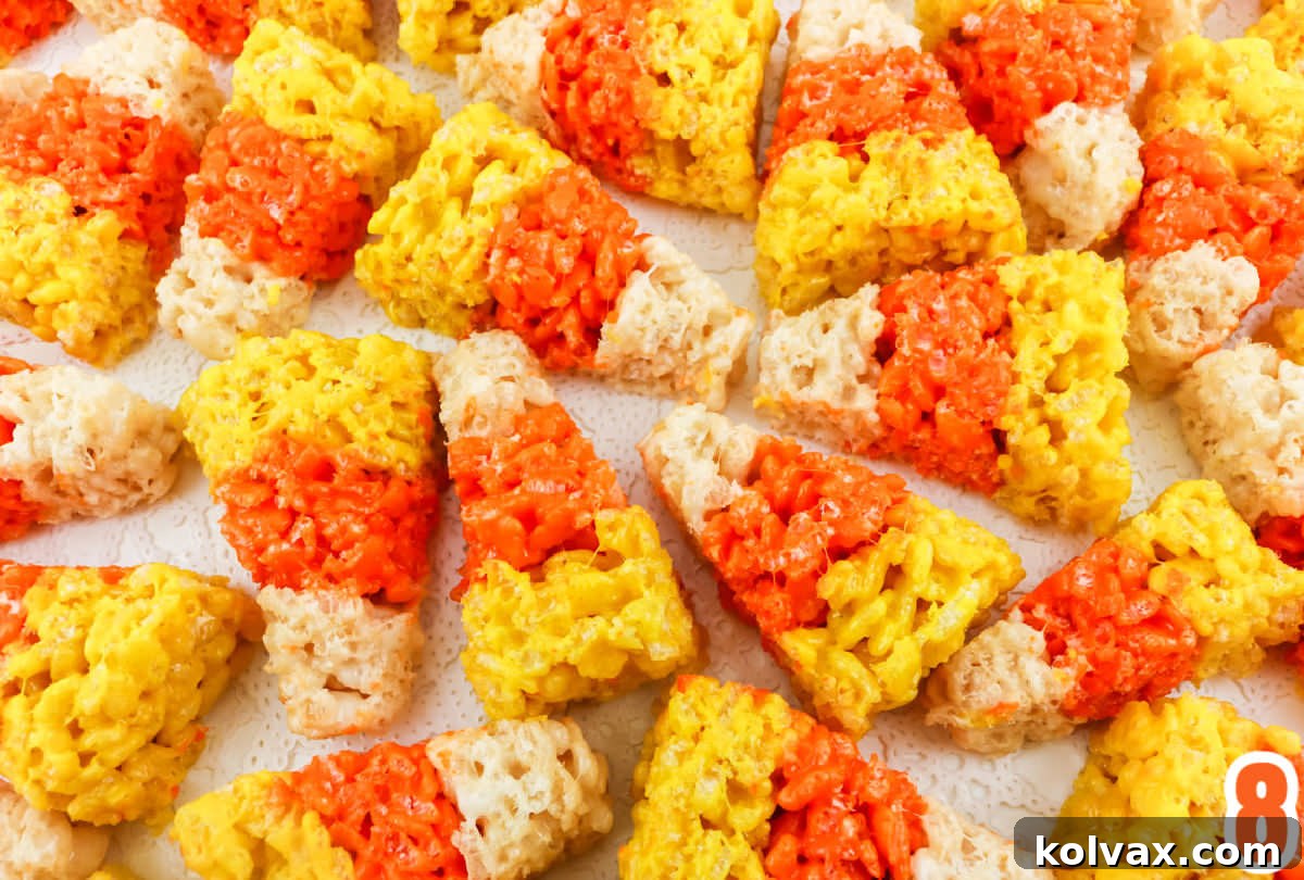 Candy Corn Crunch Bars 7 Closeup on Candy Corn Rice Krispie Treats laying on a white surface.