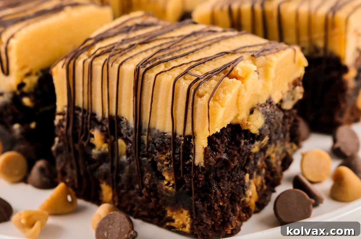 Decadent Peanut Butter Brownie Bars 2 Closeup of a Peanut Butter Brownie Bar sitting on a white platter, perfectly sliced and showcasing its luscious layers of fudgy brownie, creamy peanut butter frosting, and chocolate drizzle. Surrounded by scattered chocolate and peanut butter chips.