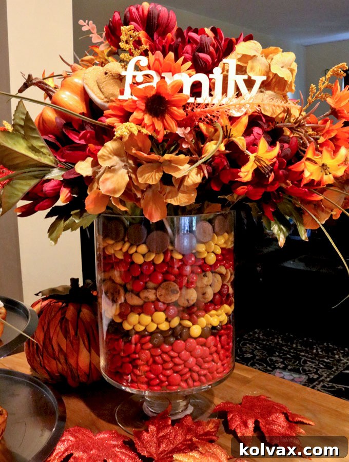 Thanksgiving Candy Centerpiece featuring M&M's, flowers, Peeps on sticks, and a 'Family' sign