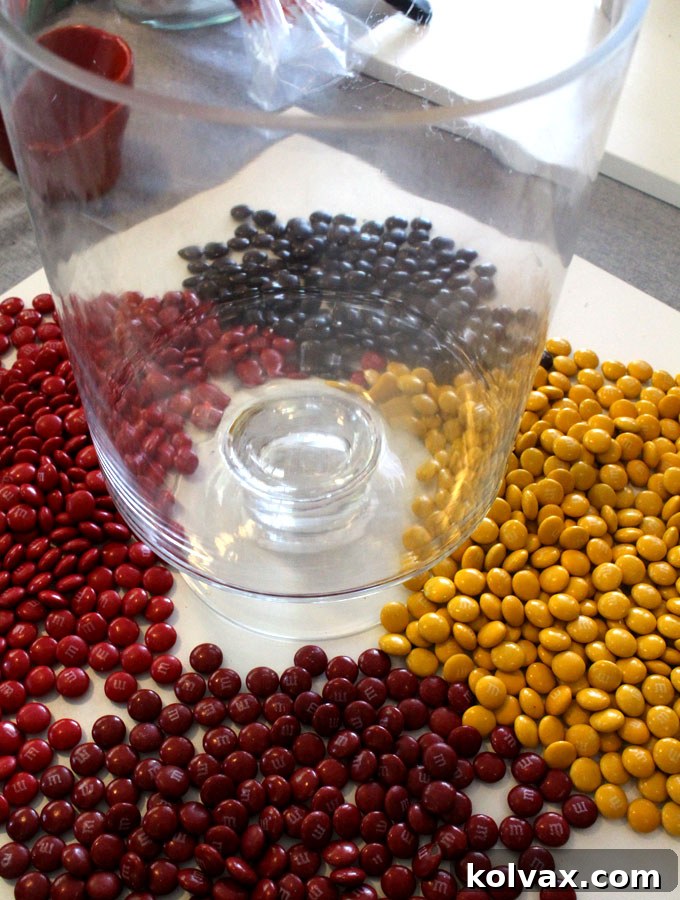 Clear Hurricane Vase prepared for candy layers with an inner ramekin and small vase