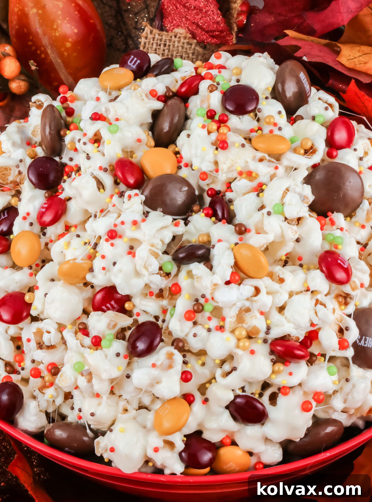 Closeup on a red serving bowl filled with Fall Harvest Popcorn.