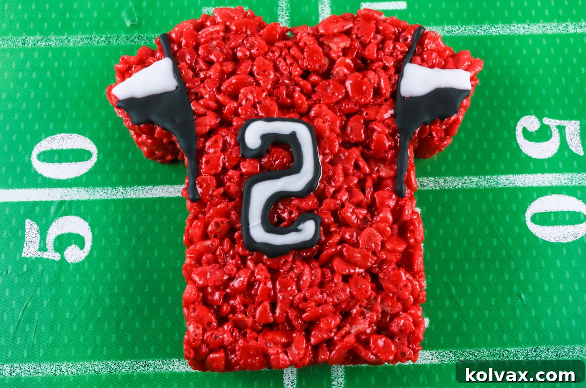 A finished Atlanta Falcons team jersey Rice Krispie Treat, intricately decorated with black and white icing details and player numbers.