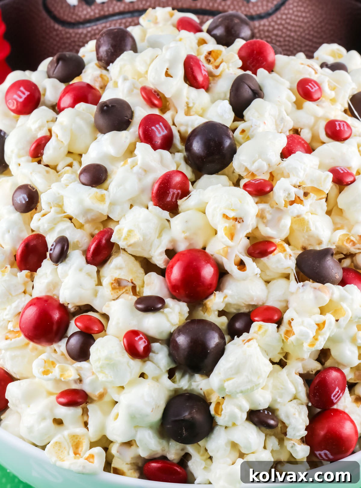 A white serving bowl brimming with festive Atlanta Falcons Popcorn, showcasing the team's red, white, and black colors in a delightful snack mix.