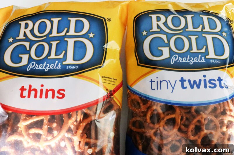 Closeup on two bags of Rold Gold pretzels, featuring both thins and tiny twists, ready for dipping.