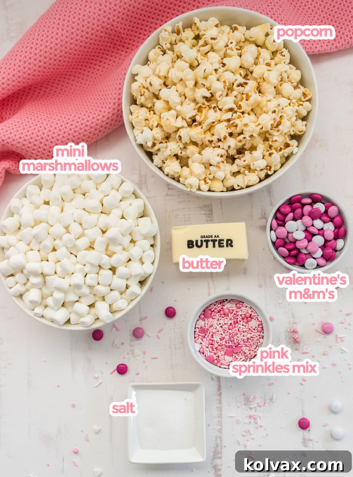 All the ingredients you will need to make Pretty Pink Party Popcorn including popcorn, marshmallows, butter, salt, pink sprinkles and Valentine's mix M&M's.