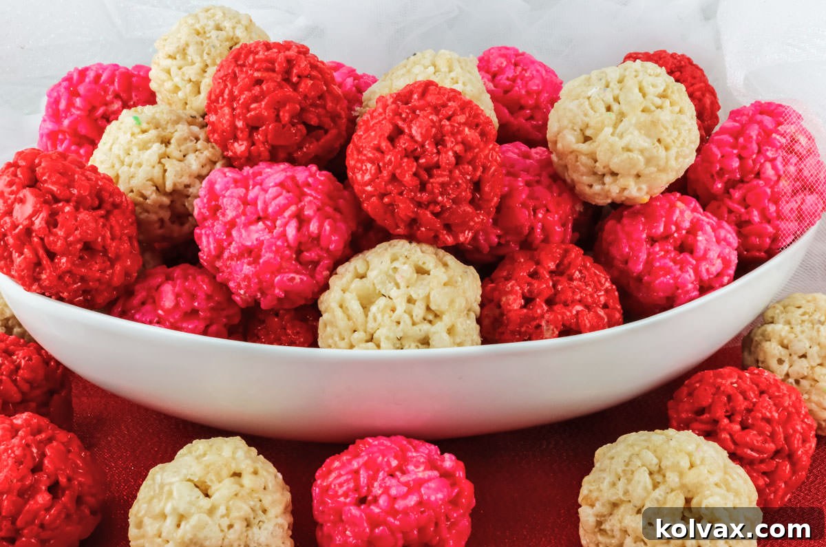Valentine's Day Rice Krispie Treat Bites in a white serving bowl sitting on a red placemat.