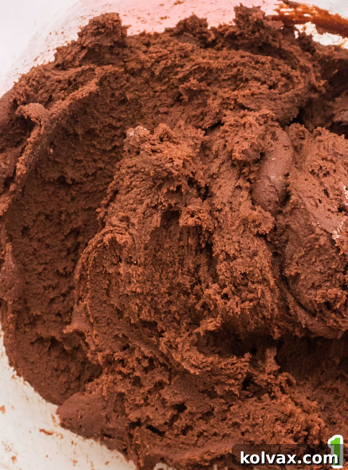 Closeup of a bowl of chocolate cookie dough used to make St. Patrick's Day Mint M&M Cookies.