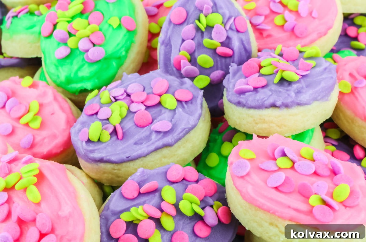 Close up on a bowl of vibrant Easter Egg Cookies frosted with green, pink, and purple buttercream frosting, ready for a festive celebration.