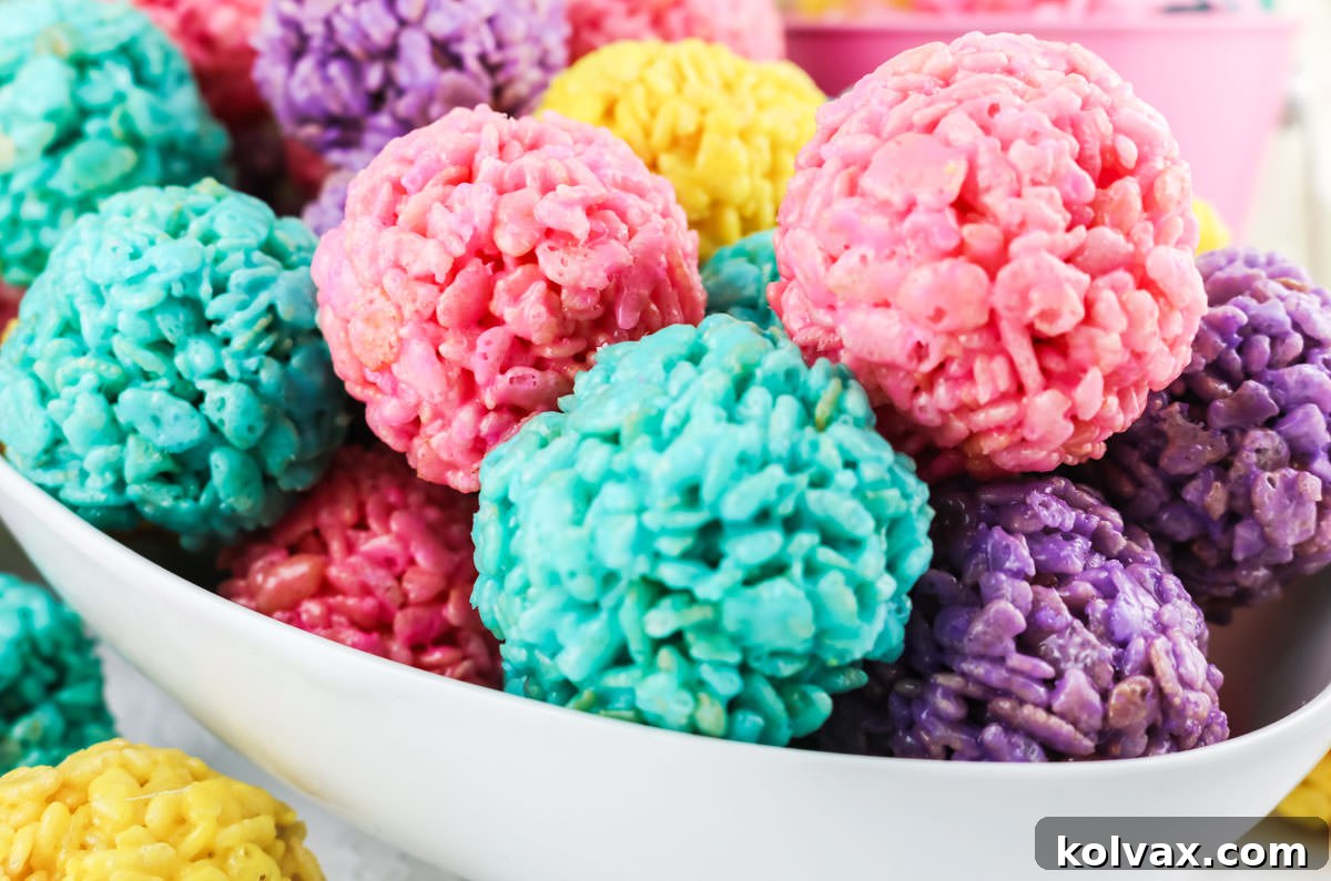 White oblong serving dish filled with pink, yellow, purple and blue Easter Rice Krispie Treat Bites. These colorful and festive Easter treats are sure to please your loved ones, great for Mother's Day, a Spring Brunch or just a random Monday.