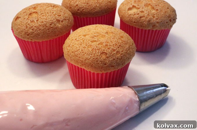 Pink Lemonade Cloud Cupcakes 4 Close-up of the smooth, vibrant 'The Best Pink Lemonade Frosting' in a bowl.