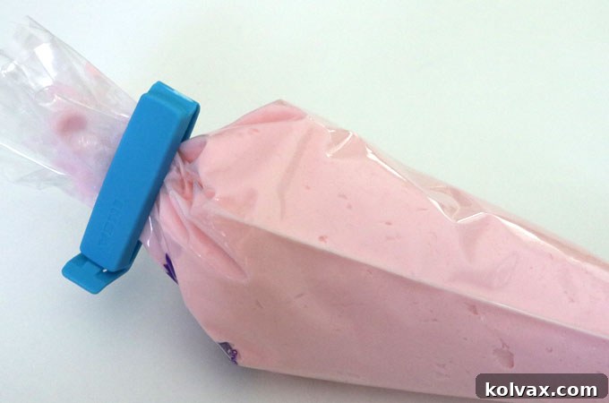 Tying off the end of the piping bag securely with a clip for controlled frosting application