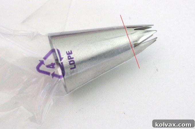 Trimming the piping bag to ensure the tip is perfectly positioned for frosting cupcakes