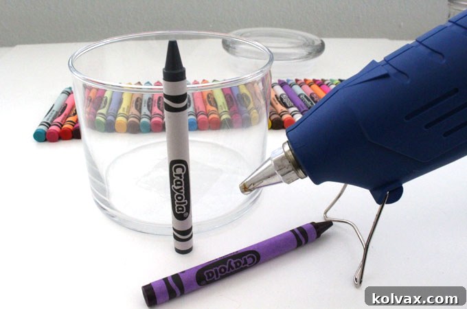 Carefully Gluing the First Crayon onto the Glass Jar