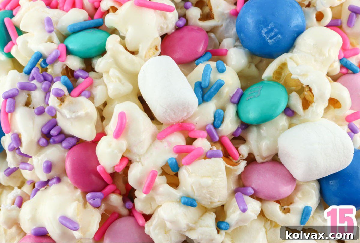 Closeup on a bowl of Trolls Popcorn featuring popcorn, mini marshmallows, M&M's and sprinkles.