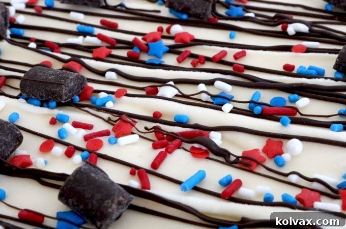 Decorated Patriotic Ice Cream Cookie Pizza with sprinkles and chocolate drizzle