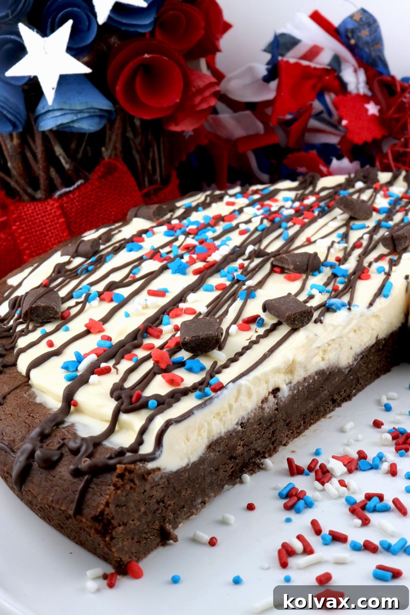 A slice of Patriotic Ice Cream Cookie Pizza, showing the cookie and ice cream layers