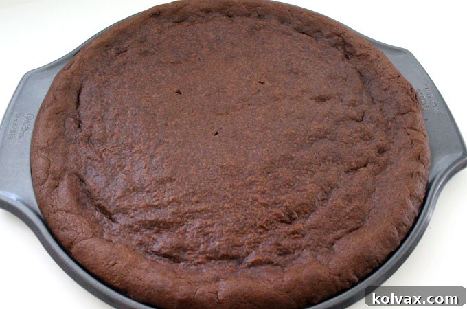 Baked chocolate cookie base for ice cream pizza, out of the oven