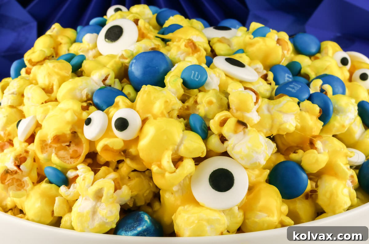 Closeup of a white bowl filled with Minions Popcorn in front of a blue background.