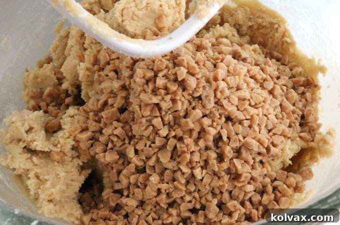 Freshly prepared Toffee Chip Cookie dough in a mixing bowl, ready for shaping.