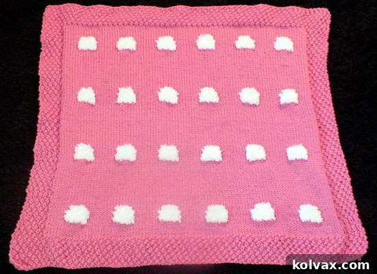 Completed knitted blanket before adding sheep embroidery