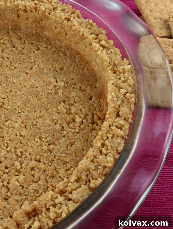 A perfectly set and golden-brown homemade Graham Cracker Crust, ready to be filled with your favorite dessert creation.