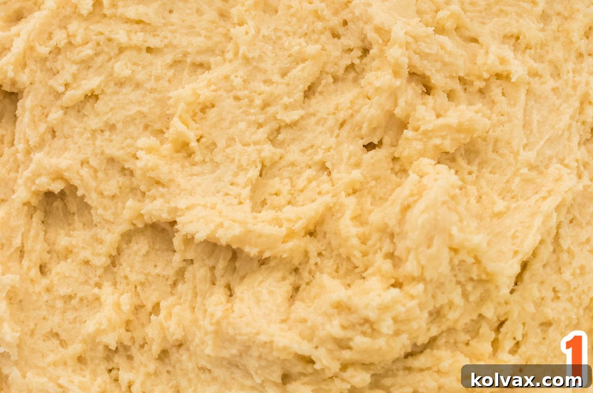 Marbled Harvest Sugar Cookie Bars 3 A large mixing bowl containing freshly prepared sugar cookie bar dough, ready for the next step of coloring.