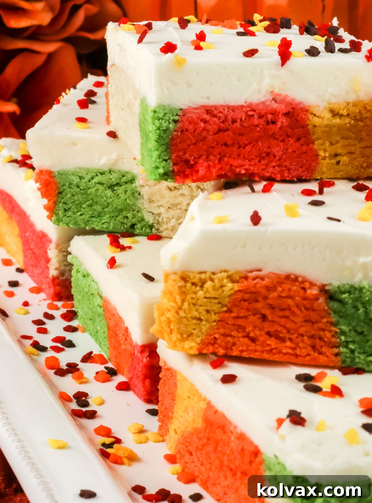 Marbled Harvest Sugar Cookie Bars 10 A beautiful white serving platter overflowing with individually cut Harvest Marble Sugar Cookie Bars, garnished with vibrant fall sprinkles, ready to be served.