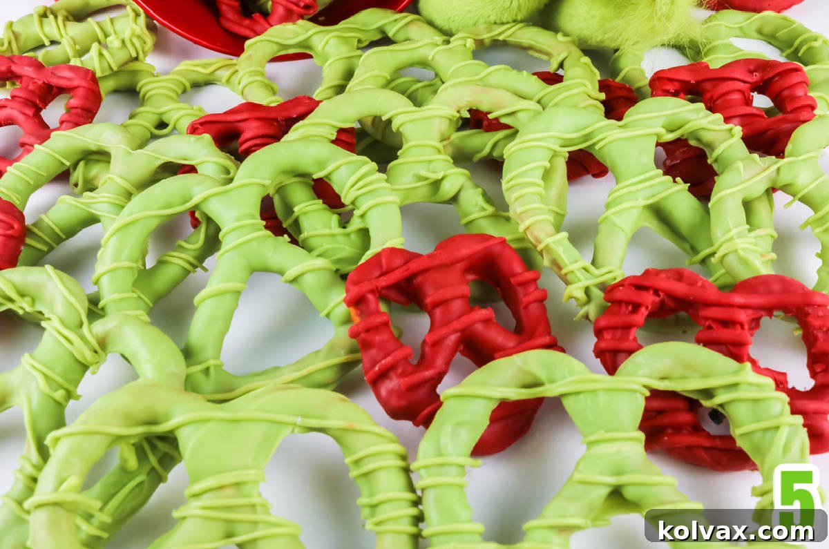 Red and Green Grinch Heart Pretzels spilling out in a random pattern on a white surface.