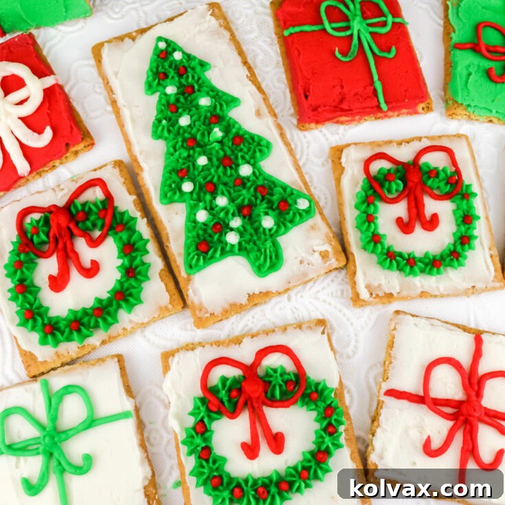 Christmas Frosted Graham Crackers - A batch of crunchy graham crackers beautifully decorated with vibrant red, green, and white buttercream frosting and festive holiday designs, ready to be enjoyed as an easy and delicious holiday treat.