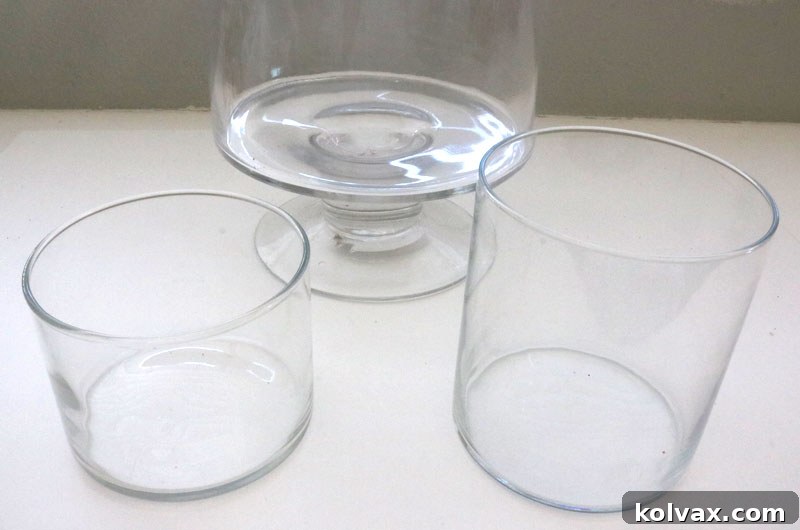 Clear glass hurricane vase and smaller cylinder vase, illustrating the essential containers for constructing the Christmas candy centerpiece.