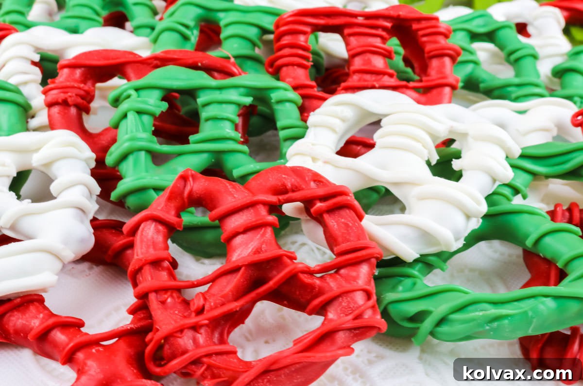 A vibrant display of red, white, and green Christmas Pretzels laid out on a white tablecloth, ready for holiday festivities.