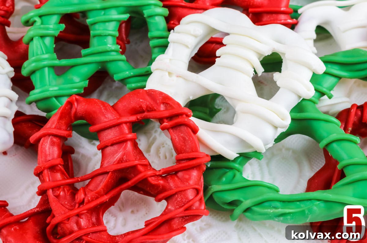 A close-up view of perfectly dipped and drizzled Christmas Pretzels in festive red, white, and green colors.