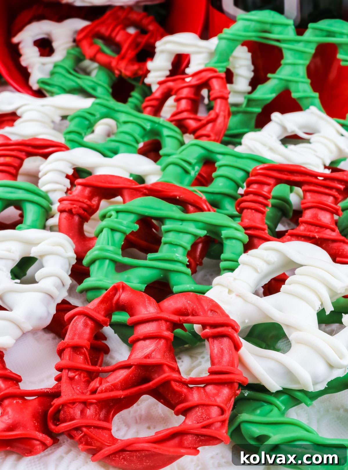 A generous batch of colorful Christmas Pretzels artistically scattered on a clean white surface.