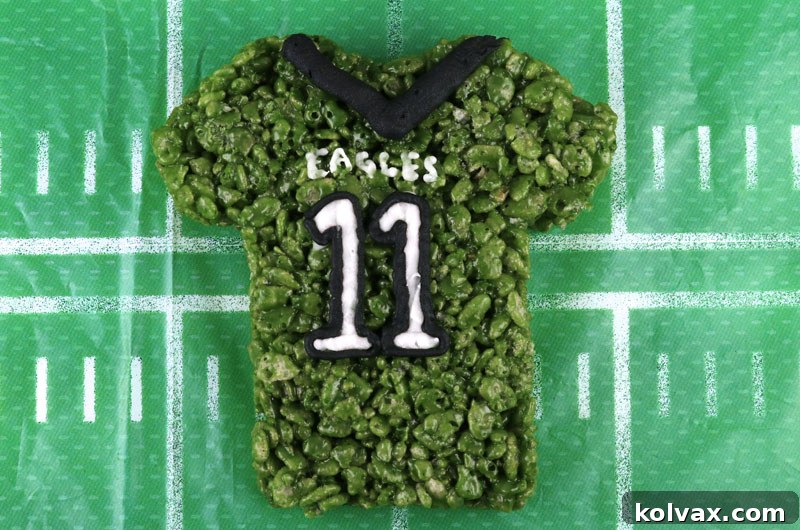 Decorating Philadelphia Eagles Rice Krispie Treats with iconic team details.